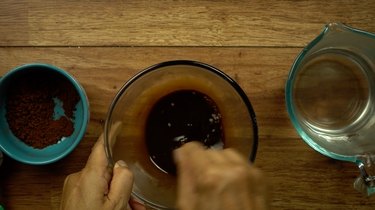 Mixing instant coffee and hot water for easy way to stain wood with coffee.
