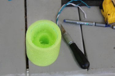 Hollow out the center of the cup holder with the box-cutter.
