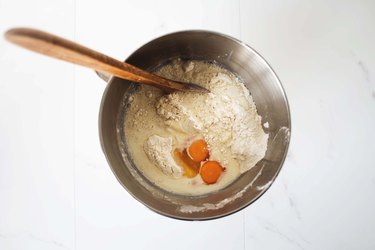 Adding the milk and eggs to the dry ingredients.
